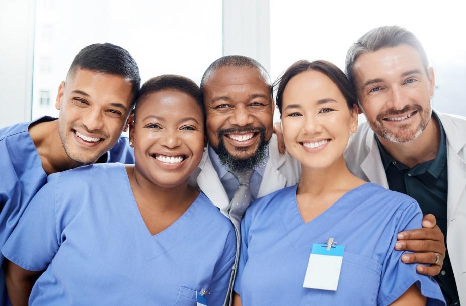 A group of medical professionals posing for a photo Description automatically generated